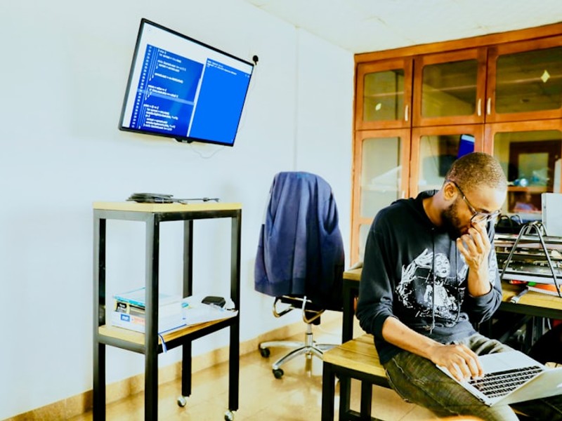 man using silver MacBook while sitting