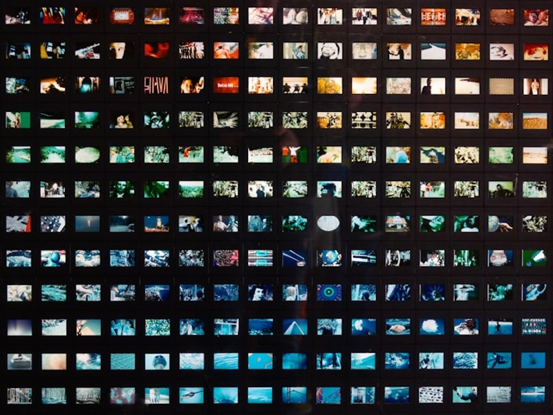 a black wall with a lot of different pictures on it
