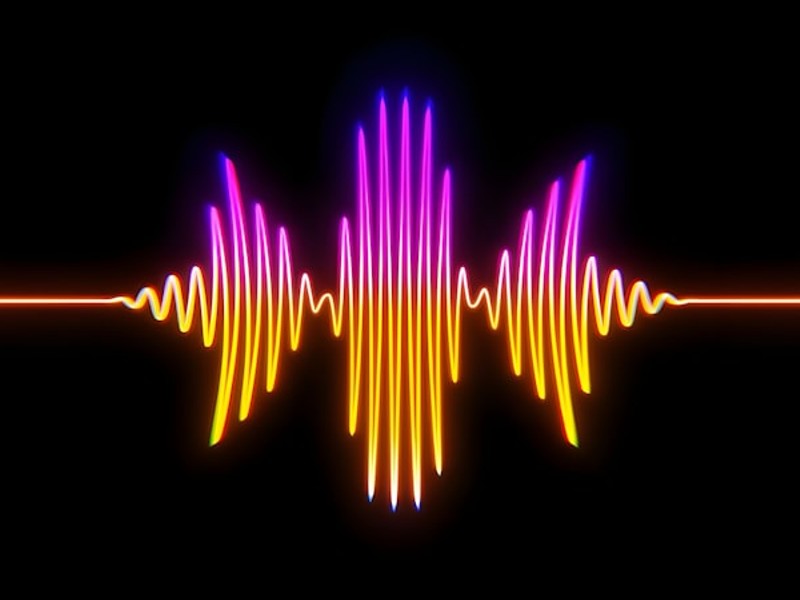 A colorful sound wave on a black background