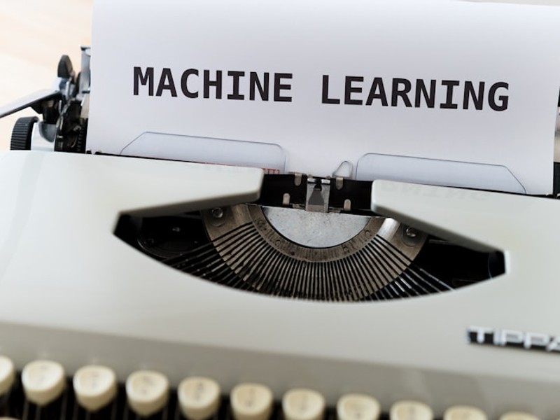 a close up of a typewriter with a paper reading machine learning