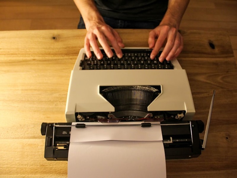 person holding white printer paper
